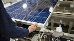 A production line worker helps assemble solar panels. A production line worker helps assemble solar panels.