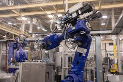 As part of the Roper plant’s two 500-foot-long assembly lines that manufacture GE gas, electric or induction ovens, robot arms pick up and reposition oven cavities and cooktops. As part of the Roper plant’s two 500-foot-long assembly lines that manufacture GE gas, electric or induction ovens, robot arms pick up and reposition oven cavities and cooktops.