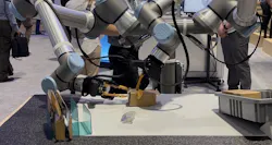 On the Automate show floor, Universal Robots showcased AI-powered robots performing a task of putting together a small cardboard box.